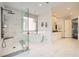 Bright bathroom featuring white tile, a glass shower, and a luxurious soaking tub at 3111 Lido Isle Ct, Las Vegas, NV 89117
