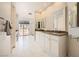 Bright bathroom features double sinks, vanity, tile floors, glass shower doors, and outdoor access at 3111 Lido Isle Ct, Las Vegas, NV 89117