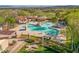 Aerial view of a large community pool with water slides, splash pads, and surrounding green spaces at 3111 Lido Isle Ct, Las Vegas, NV 89117