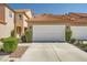 Well-maintained townhome featuring a two-car garage and lush green shrubbery at 3111 Lido Isle Ct, Las Vegas, NV 89117