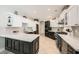 Modern kitchen with black and white cabinets, stainless appliances, and a large island with a marble countertop at 3111 Lido Isle Ct, Las Vegas, NV 89117