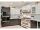 Modern kitchen with gas range, custom cabinets, and stainless steel appliances at 3111 Lido Isle Ct, Las Vegas, NV 89117