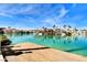 Scenic lakefront view of luxury homes with docks, captured from a wooden dock on a sunny day at 3111 Lido Isle Ct, Las Vegas, NV 89117