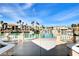 Waterfront homes with private docks line a tranquil lake under a clear sky; viewed from a shaded patio at 3111 Lido Isle Ct, Las Vegas, NV 89117