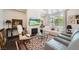 Bright living room with fireplace, large windows, and comfortable seating arrangement at 3111 Lido Isle Ct, Las Vegas, NV 89117