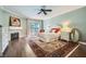 Inviting primary bedroom with a fireplace, light blue walls, white trim, and a balcony with lots of light at 3111 Lido Isle Ct, Las Vegas, NV 89117