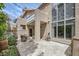 Rear exterior featuring a covered patio with outdoor seating and a lush landscaped yard at 3111 Lido Isle Ct, Las Vegas, NV 89117