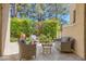 Charming patio with comfortable seating surrounded by lush greenery and potted plants at 3111 Lido Isle Ct, Las Vegas, NV 89117