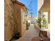 Charming patio area with a small table and chairs, framed by stucco walls and greenery under a clear sky at 3111 Lido Isle Ct, Las Vegas, NV 89117