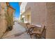 A quaint outdoor patio with seating is nestled between two stucco walls and has an overhead covering at 3111 Lido Isle Ct, Las Vegas, NV 89117