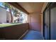 Balcony featuring dark flooring, a pink door, and a view of the complex's exterior at 3151 Soaring Gulls Dr # 1181, Las Vegas, NV 89128