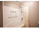 Bathroom with a shower and bathtub with white tiles, and chrome fixtures at 3151 Soaring Gulls Dr # 1181, Las Vegas, NV 89128