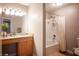 Bathroom featuring a vanity, shower, and decorative mirror with vanity lighting at 3151 Soaring Gulls Dr # 1181, Las Vegas, NV 89128