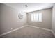 Bedroom featuring neutral walls, carpet, and a window with white shutters for ample natural light at 3151 Soaring Gulls Dr # 1181, Las Vegas, NV 89128
