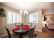 Cozy dining area featuring a round table, chandelier, and plantation shutters at 3151 Soaring Gulls Dr # 1181, Las Vegas, NV 89128