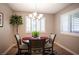 Cozy dining room featuring a round table, chandelier, and plantation shutters at 3151 Soaring Gulls Dr # 1181, Las Vegas, NV 89128