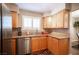 The kitchen features stainless steel appliances, wood cabinets, and granite countertops at 3151 Soaring Gulls Dr # 1181, Las Vegas, NV 89128