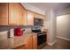 A well-lit kitchen with wood cabinets, granite countertops, and stainless steel appliances at 3151 Soaring Gulls Dr # 1181, Las Vegas, NV 89128