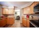 The kitchen features wood cabinets, granite countertops, stainless steel appliances and views to dining area at 3151 Soaring Gulls Dr # 1181, Las Vegas, NV 89128