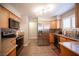 Updated kitchen featuring stainless steel appliances, wood cabinets, and stone countertops at 3151 Soaring Gulls Dr # 1181, Las Vegas, NV 89128