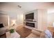 Modern living room includes hardwood floors, a sleek TV, and an electric fireplace at 3151 Soaring Gulls Dr # 1181, Las Vegas, NV 89128