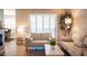 The living room is filled with natural light from a window and showcases neutral toned decor and furniture at 3151 Soaring Gulls Dr # 1181, Las Vegas, NV 89128