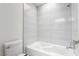 Bathroom with white tile, bathtub, and shower combination at 3246 Brookfield Dr, Las Vegas, NV 89120