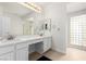 Bright bathroom with double sinks, marble countertops, and glass block window at 3246 Brookfield Dr, Las Vegas, NV 89120