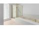 Bathroom features a tub, glass shower, and unique glass block window at 3246 Brookfield Dr, Las Vegas, NV 89120