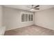 Carpeted bedroom featuring a ceiling fan, and plantation shutters at 3246 Brookfield Dr, Las Vegas, NV 89120