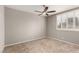Bright bedroom with carpet, ceiling fan, and window with white shutters at 3246 Brookfield Dr, Las Vegas, NV 89120