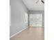 Bright bedroom featuring wood-look floors, a modern fan, and plantation shutters at 3246 Brookfield Dr, Las Vegas, NV 89120