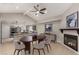 Open dining area with a fireplace, modern art, and a breakfast bar that connects to a stylish kitchen at 3246 Brookfield Dr, Las Vegas, NV 89120