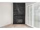 Close up of the bedroom's unique dark stone fireplace and sliding glass door at 3246 Brookfield Dr, Las Vegas, NV 89120