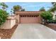 Exterior view of a one-story home featuring a tan garage door at 3246 Brookfield Dr, Las Vegas, NV 89120