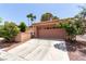 Two-car garage featuring an extended driveway and desert landscaping at 3246 Brookfield Dr, Las Vegas, NV 89120