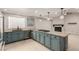 Kitchen boasts granite countertops, blue cabinets, and stainless steel appliances at 3246 Brookfield Dr, Las Vegas, NV 89120