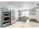 The kitchen showcases stainless steel appliances, blue cabinets, and granite countertops for style and functionality at 3246 Brookfield Dr, Las Vegas, NV 89120