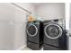 Modern laundry room with front loading washer and dryer at 3246 Brookfield Dr, Las Vegas, NV 89120