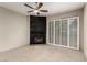Spacious living room with a stone fireplace, ceiling fan, and access to the backyard at 3246 Brookfield Dr, Las Vegas, NV 89120
