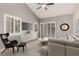 Comfortable living room features vaulted ceilings, plantation shutters, and a stylish gray sofa with modern decor at 3246 Brookfield Dr, Las Vegas, NV 89120