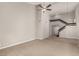 Bright living room with soaring ceilings, ceiling fan and unique black railing staircase at 3246 Brookfield Dr, Las Vegas, NV 89120
