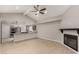 Open-concept living and kitchen area with light-tone floors, fireplace, and breakfast bar at 3246 Brookfield Dr, Las Vegas, NV 89120