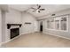 Cozy living room with modern fireplace, light wood-look floors, and natural light at 3246 Brookfield Dr, Las Vegas, NV 89120