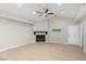 Living room featuring a modern ceiling fan, black fireplace and wood-look floors at 3246 Brookfield Dr, Las Vegas, NV 89120