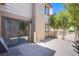 Back patio of home with stucco walls, sliding glass door access, and barbeque at 3249 Dayflower St # C, Las Vegas, NV 89121
