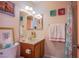 Bathroom featuring vanity, mirror, and tub/shower with colorful shower curtain at 3249 Dayflower St # C, Las Vegas, NV 89121