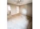 A spacious bedroom with a ceiling fan and neutral paint at 3249 Dayflower St # C, Las Vegas, NV 89121