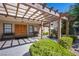 Charming clubhouse entrance with pergola, benches, and lush greenery at 3249 Dayflower St # C, Las Vegas, NV 89121