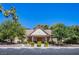 Exterior view of the well-maintained clubhouse with lush landscaping and ample parking at 3249 Dayflower St # C, Las Vegas, NV 89121